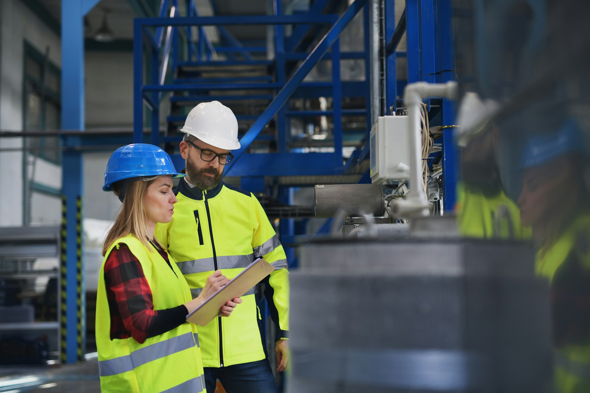 Engineering manager and mechanic worker doing routine check up in industrial factory